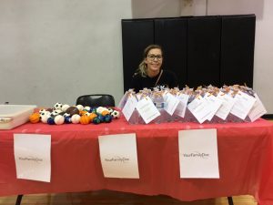 Katie sits behind our table at the Healthy Kids Fair.