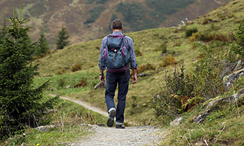 A man hikes along a winding path.